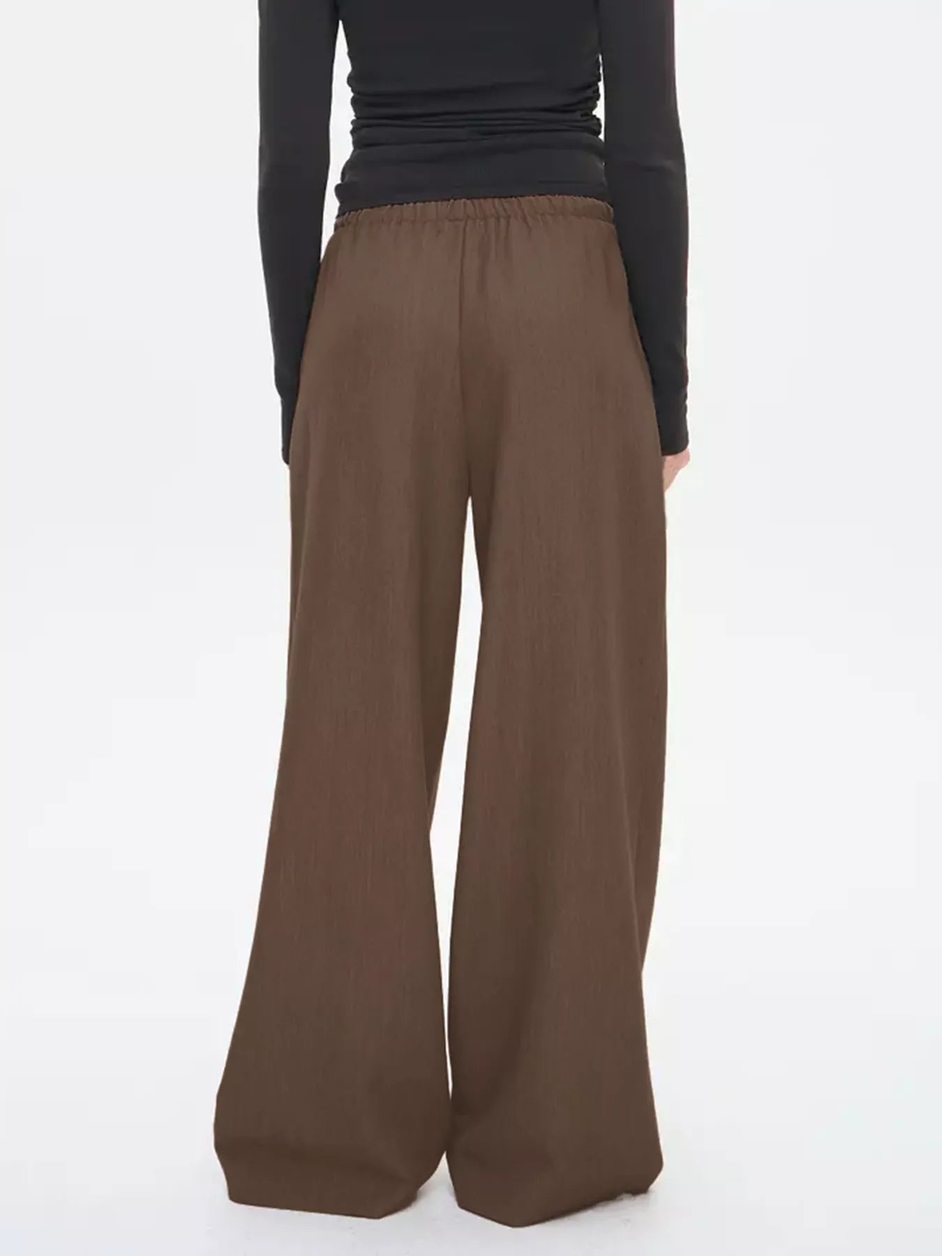 Brown wide-leg drawstring pants with elastic waistband, back view.