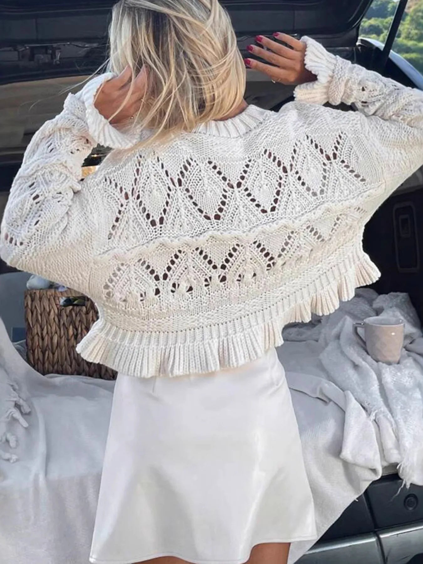 White crochet long sleeve sweater with ruffled hem and textured openwork stitch details