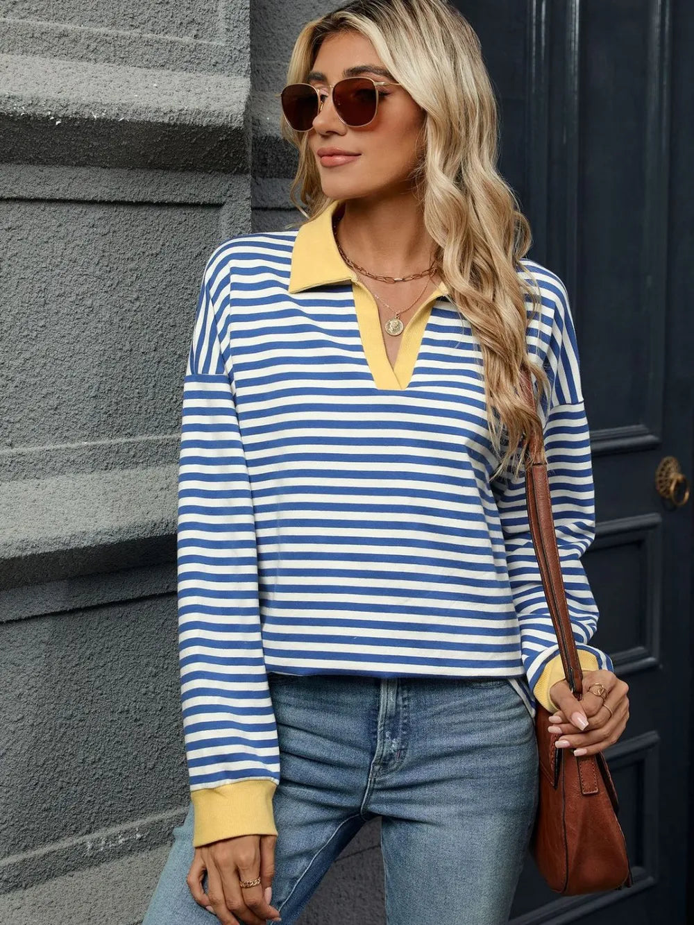 Front view of navy and white striped long-sleeve sweatshirt with tan neckline