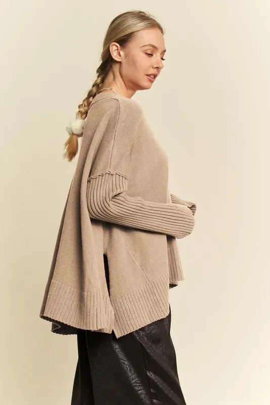 Tan ribbed V-neck sweater with side slit and wide ribbed sleeves