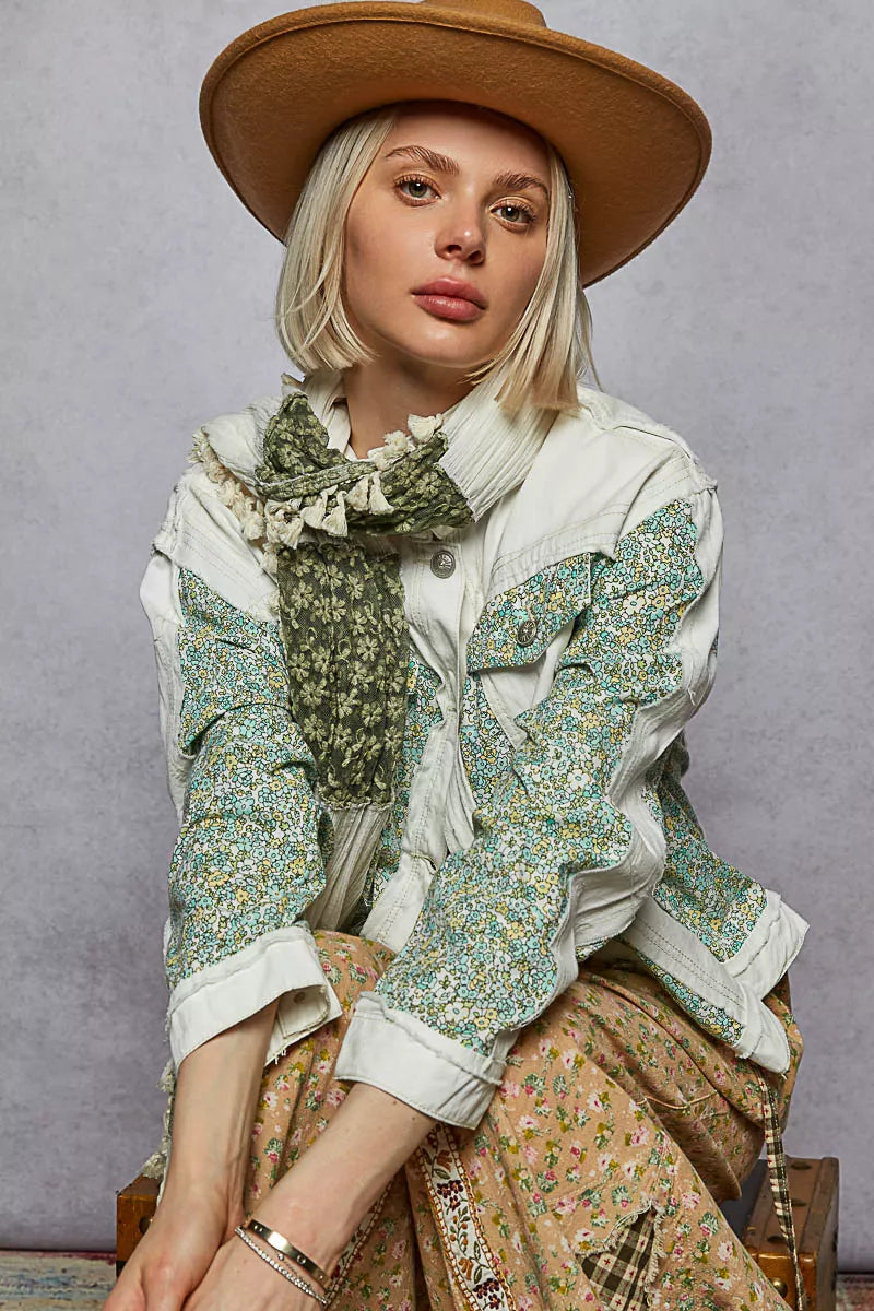 Off-white patchwork denim jacket with green floral chest pocket and button front