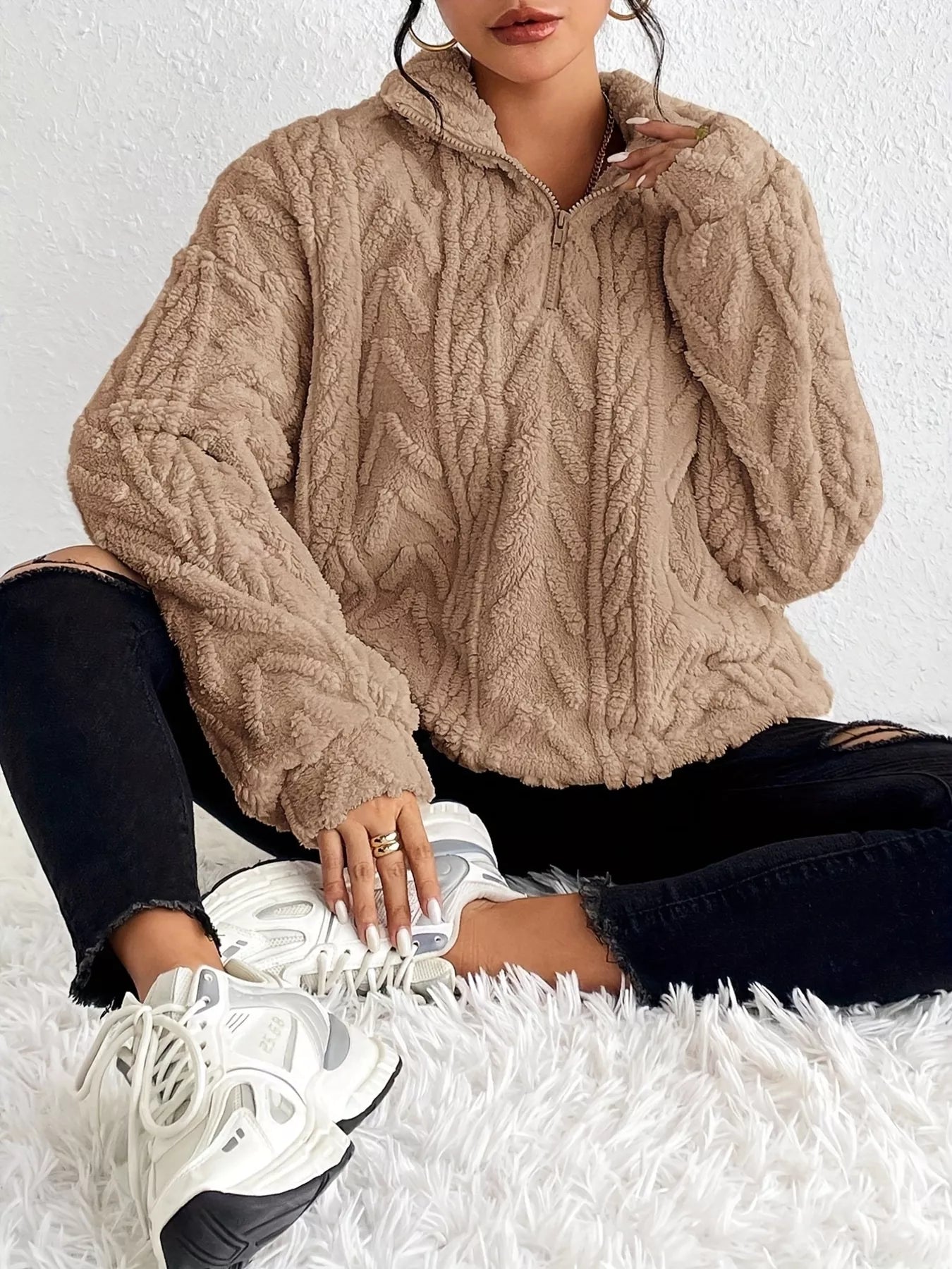 Beige sherpa quarter-zip sweatshirt with cable-knit texture and dropped shoulders