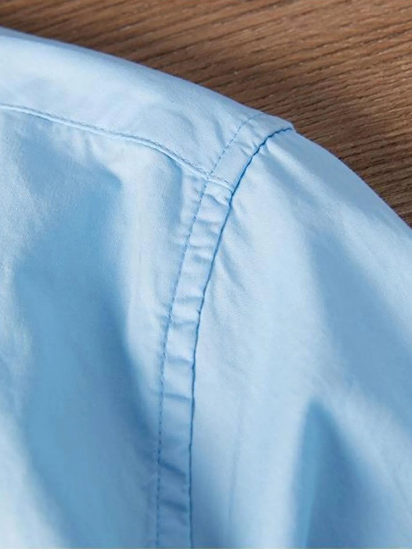 Light blue shirt back panel with center seam and hem stitching