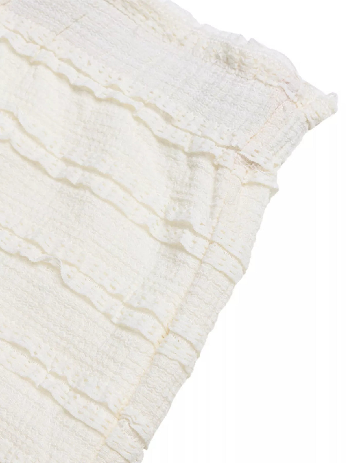 Ivory textured fabric section with crinkled surface and ruffled seam lines