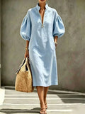 Light blue midi dress with half-zip, puff sleeves, relaxed fit, gathered cuffs