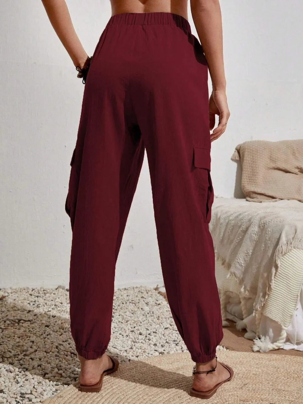 Burgundy drawstring cargo joggers with flap cargo pockets and cuffed ankles