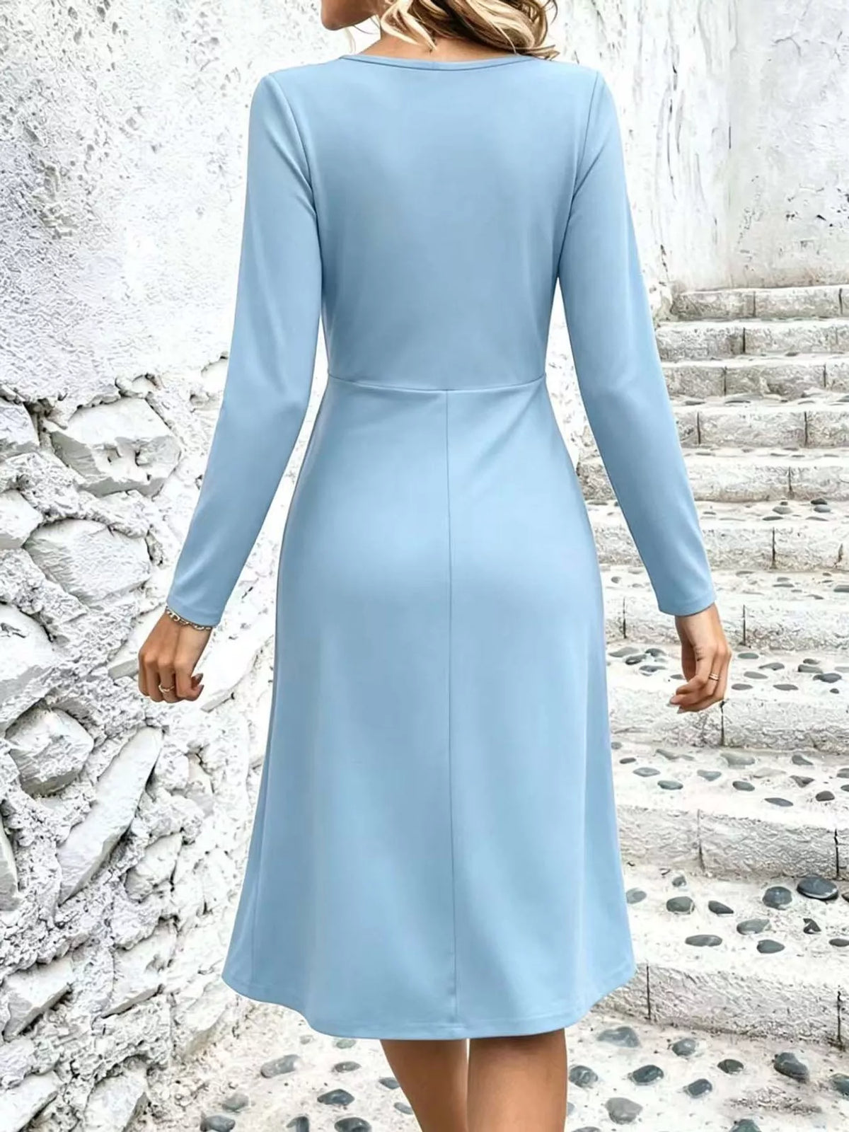 Light blue ruched midi dress with crisscross V-neck and long sleeves, back view