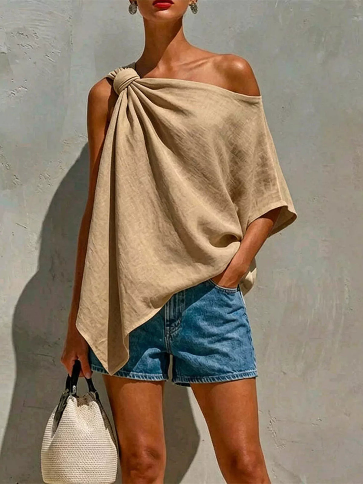 Khaki one-shoulder blouse with knotted shoulder detail and draped asymmetrical hem