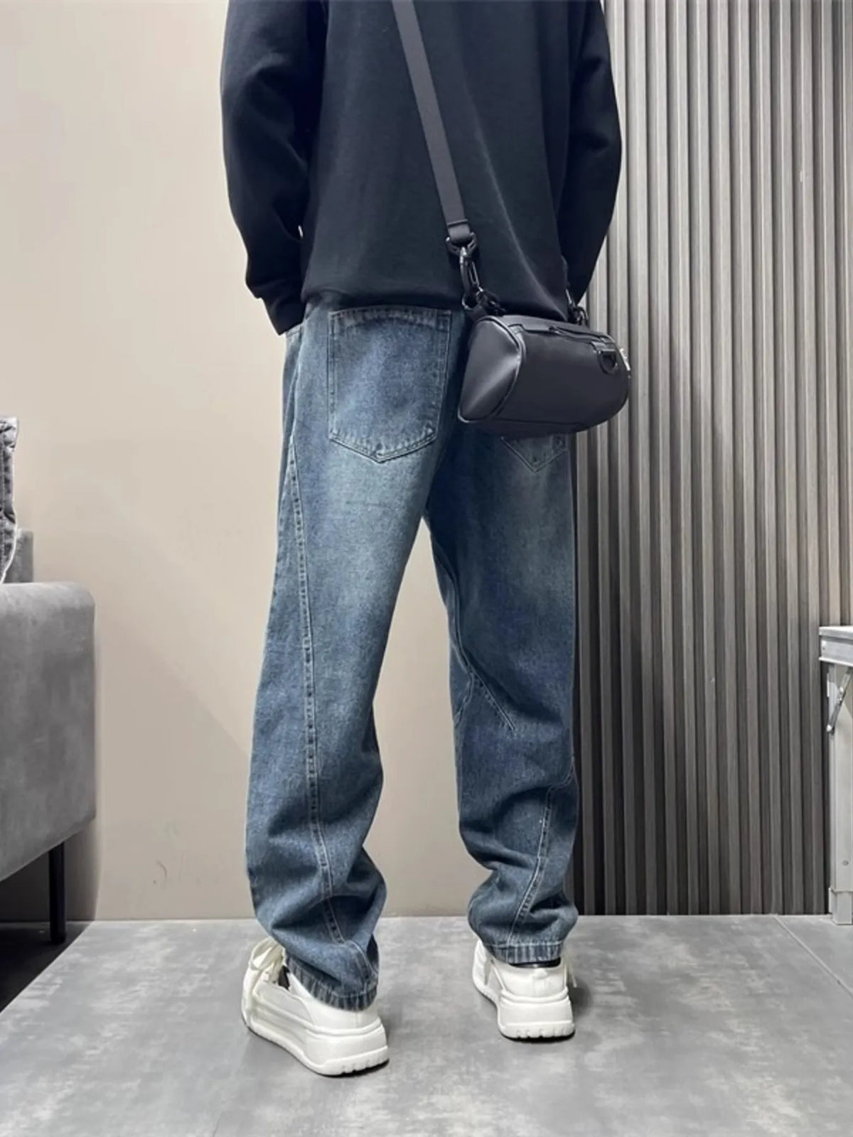 Light blue washed loose-fit stretch jeans with tapered ankles, belt loops, and back pocket
