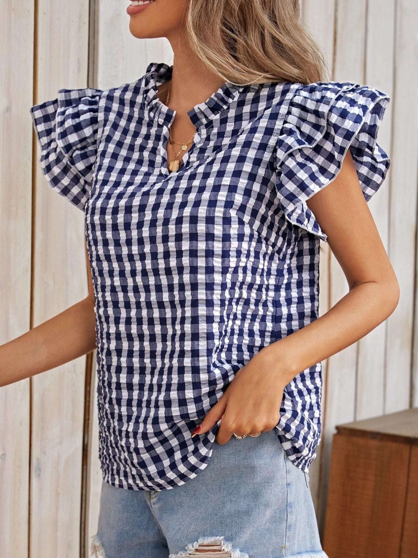 Gingham Ruffle Sleeve Blouse by Trendsi, navy and white checkered fabric with short ruffle sleeves.