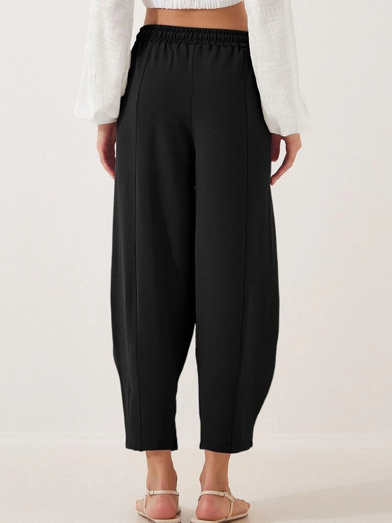 Black cropped wide-leg pants with elastic waistband and drawstring detail