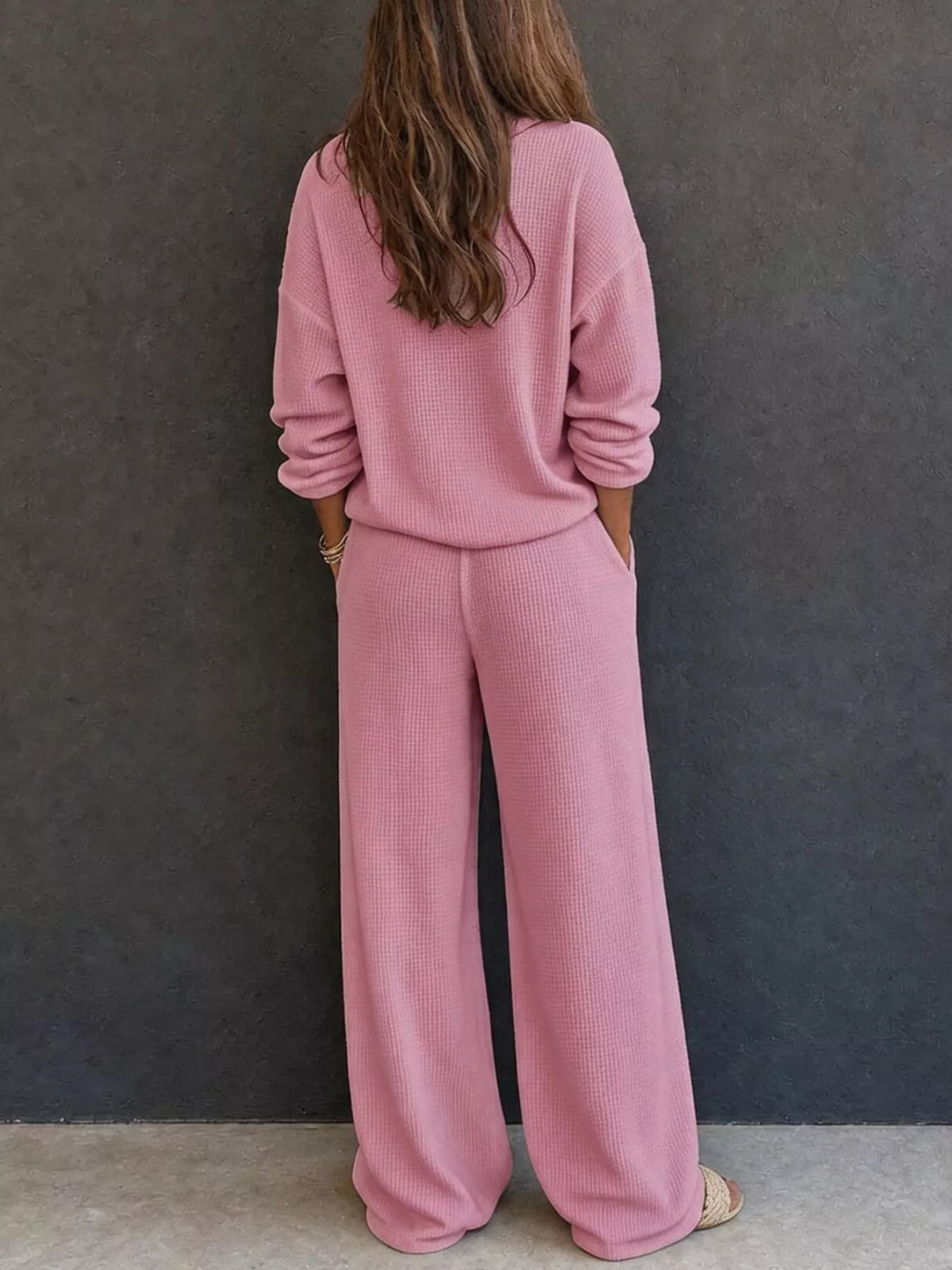 Pink waffle-knit lounge set with long sleeves and relaxed wide-leg pants, back view.