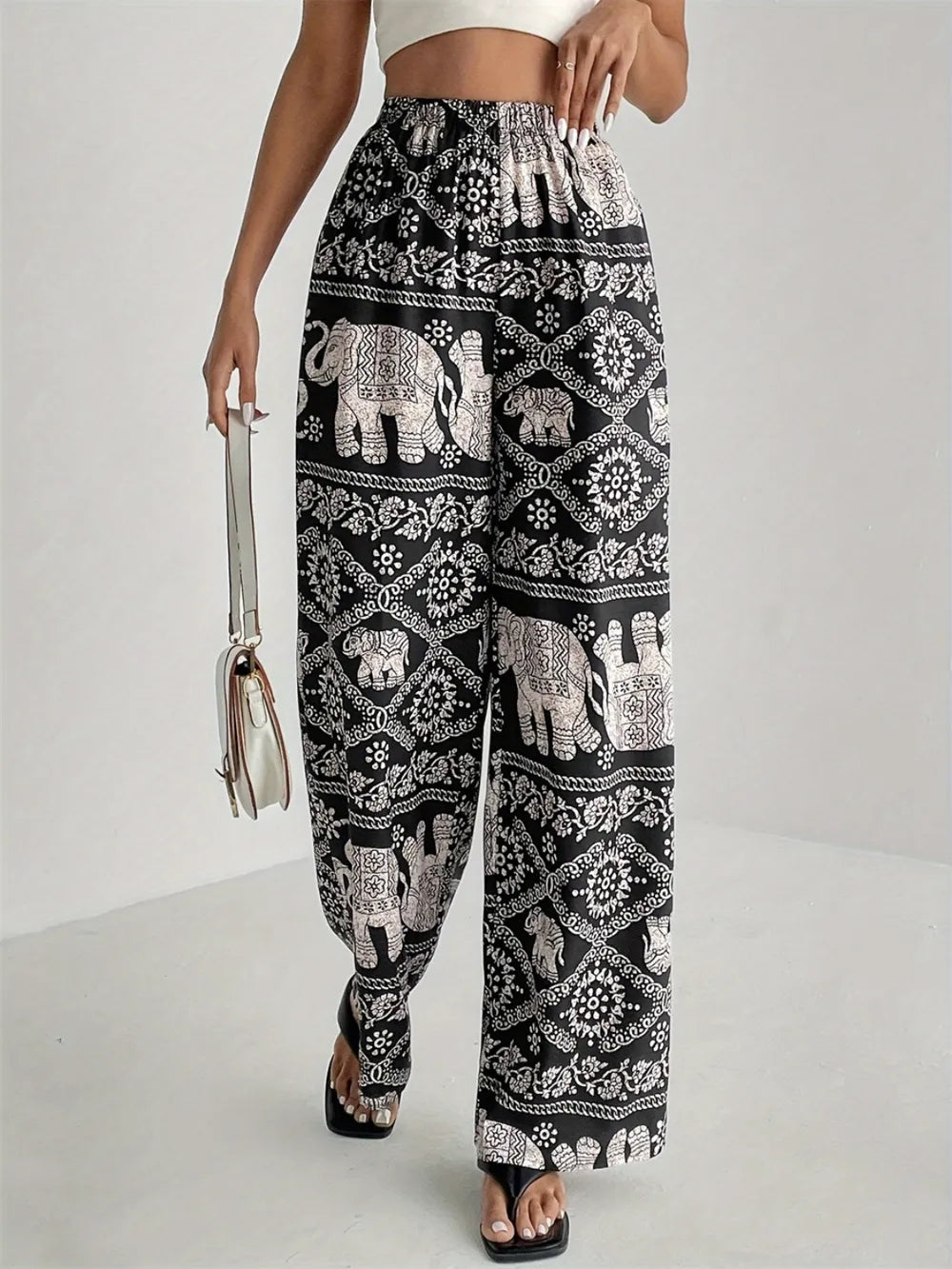 Black printed wide-leg pants with elephant print, elastic waist and loose fit