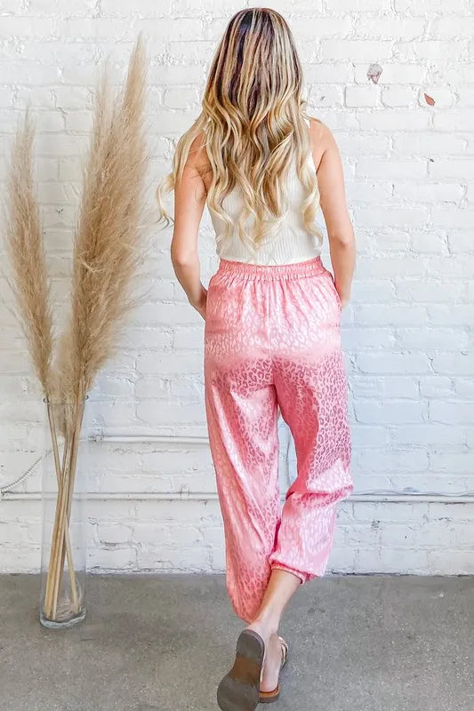 Pink satin leopard print joggers, back view with gathered elastic waist