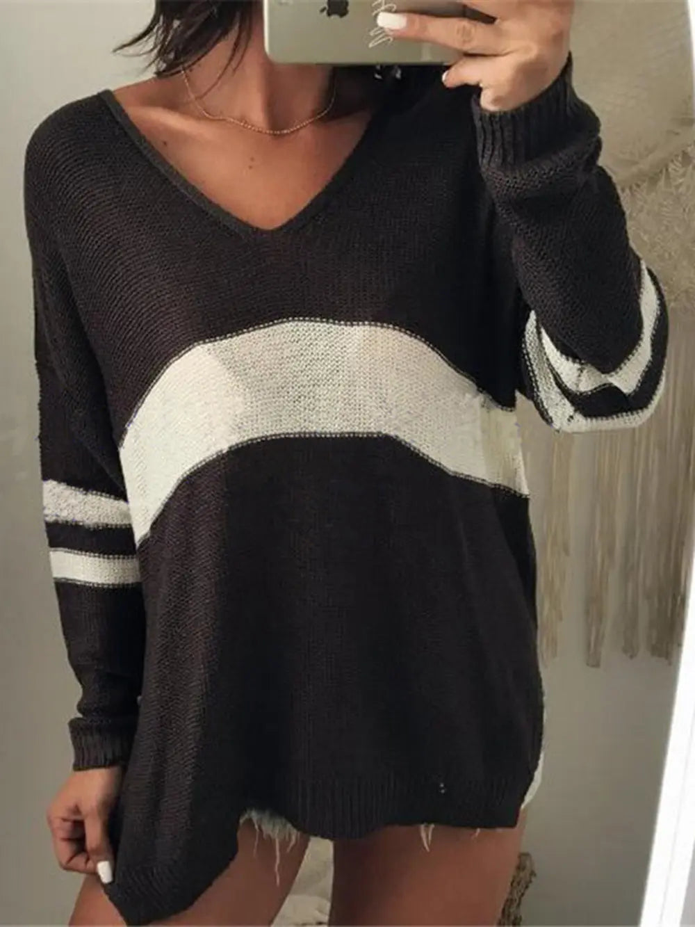 Black V-neck long-sleeve sweater with cream stripe across chest and sleeves