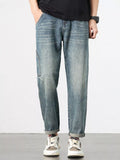 Relaxed-fit vintage washed blue jeans, straight wide legs and cuffed hems.