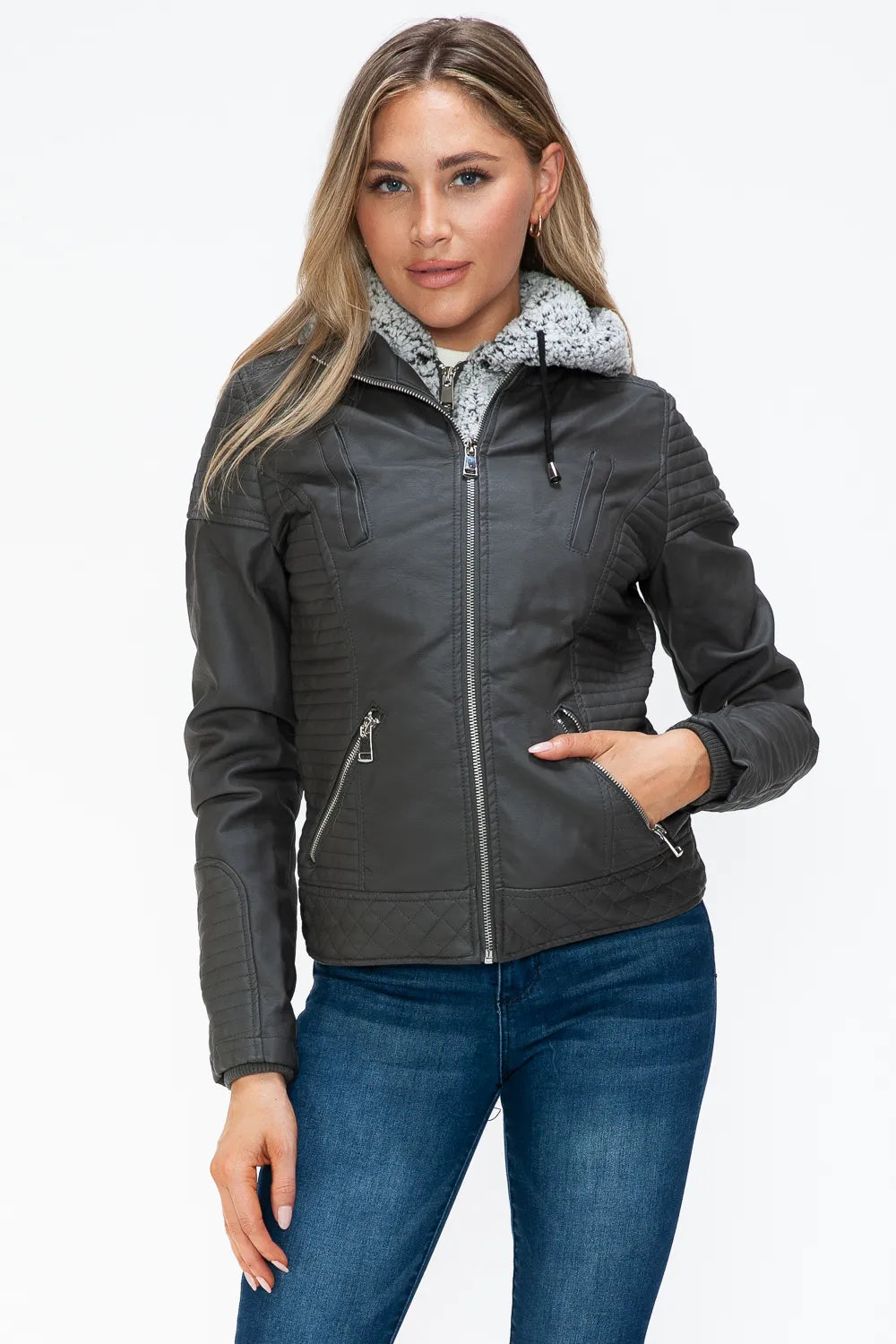 Charcoal zip jacket with fuzzy hood, front view with hand near zipper.