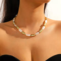 Pearl chain necklace with gold-tone spacers and white pearl segments, worn on the neck