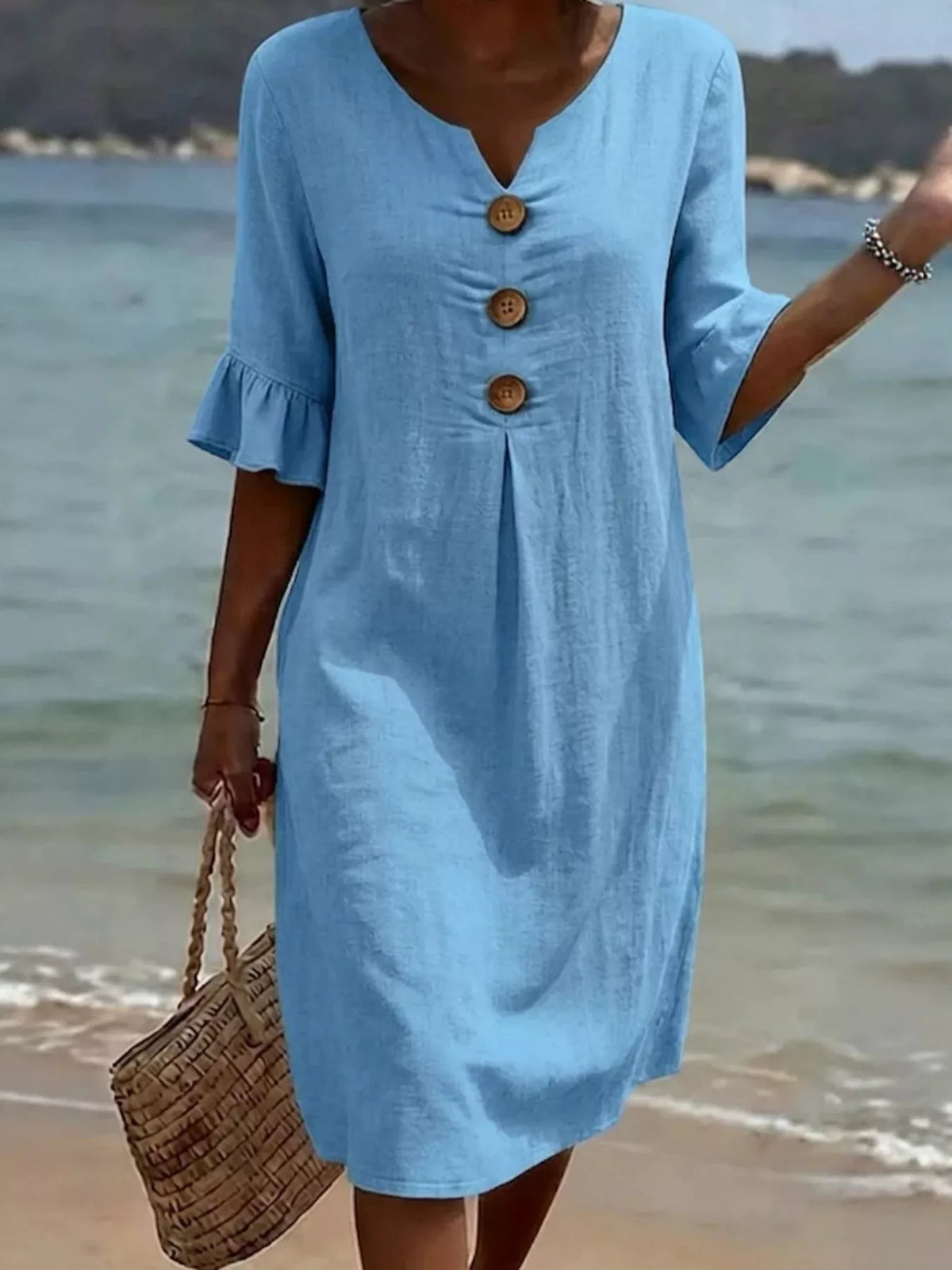 Light blue V-neck button-front midi dress with ruffle sleeves and three wood-tone buttons
