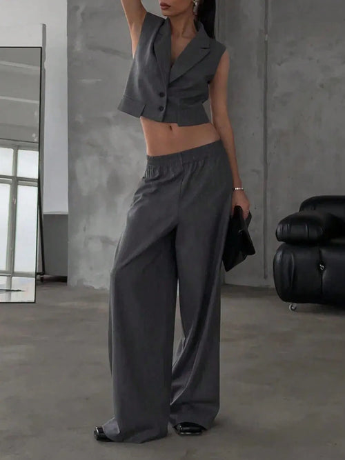 Dark gray sleeveless button-front cropped top with wide-leg drawstring pants