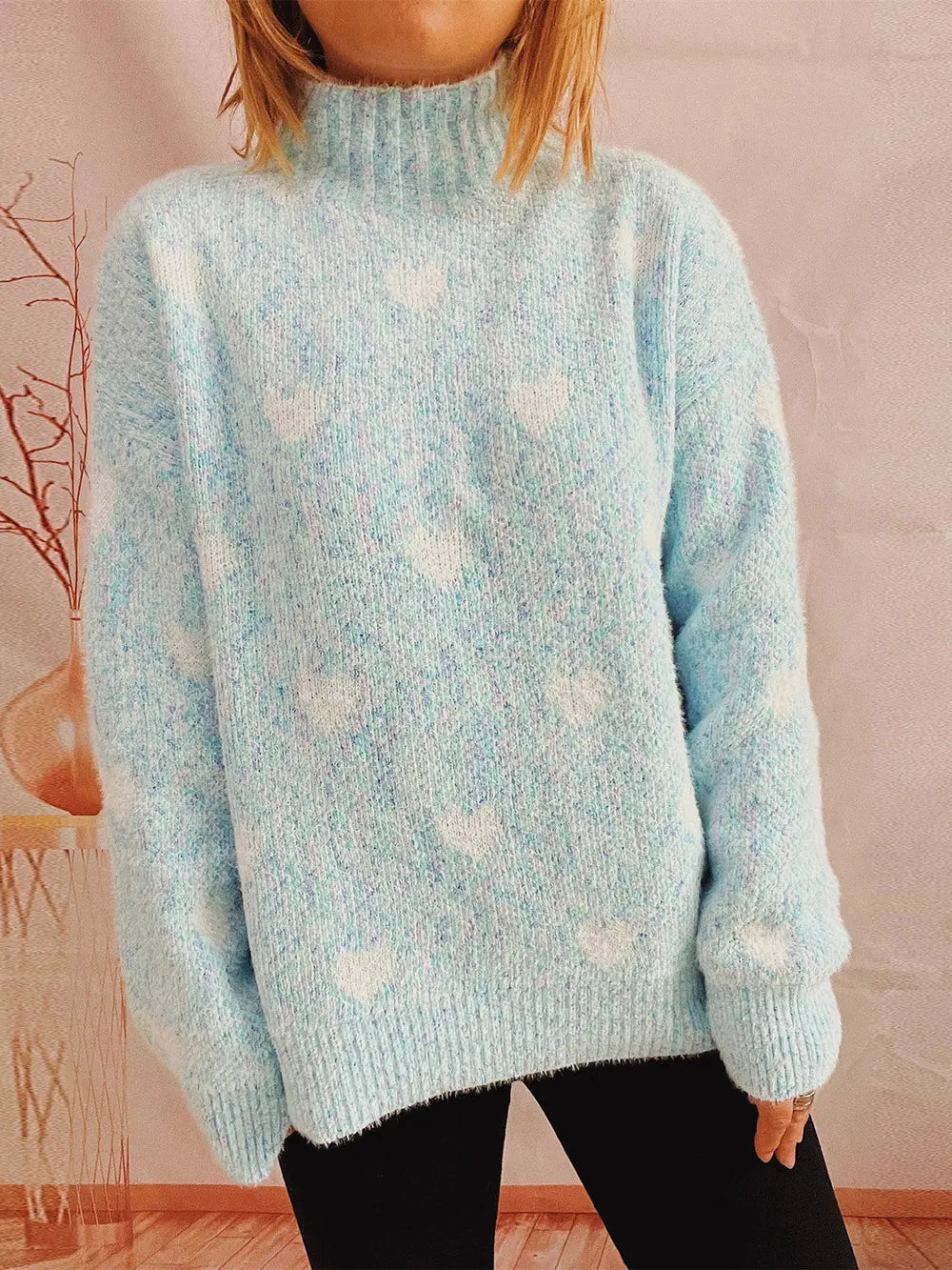 Heart-patterned heathered light blue turtleneck drop-shoulder sweater, front view