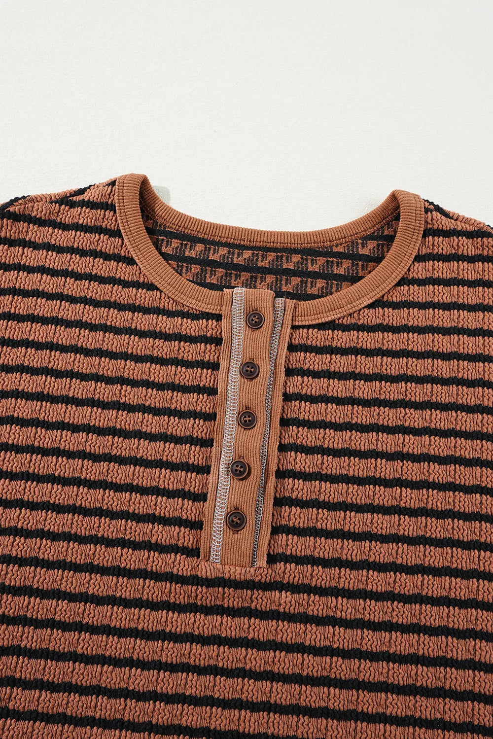 Caramel striped henley blouse with button placket and ribbed neckline close-up
