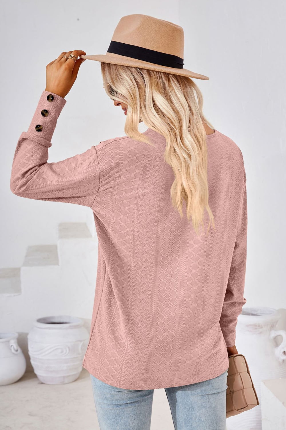 Blush pink V-neck long-sleeve blouse back view with diamond texture
