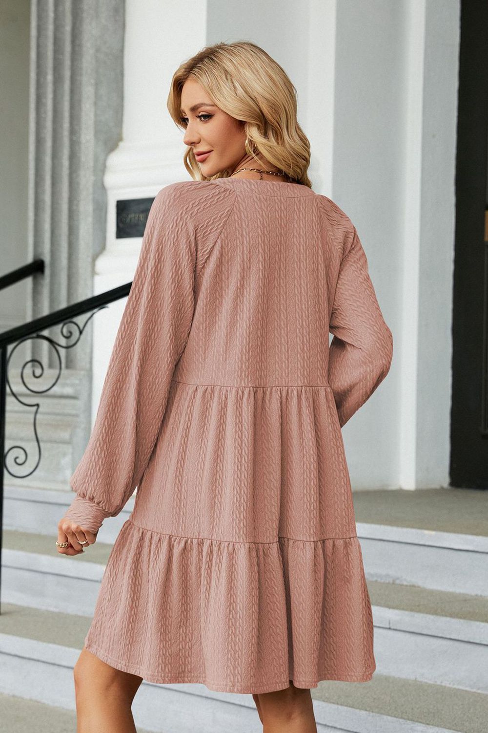 Dusty pink notched-neck long-sleeve mini dress, back view with tiered hem
