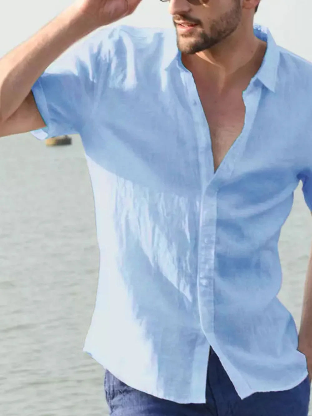 Men's short-sleeve button-down shirt, light blue, front view with button placket