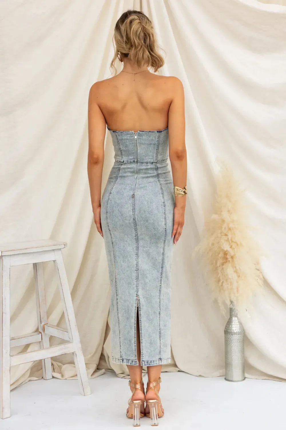 Light blue washed denim tube dress, back view with center seam and slit