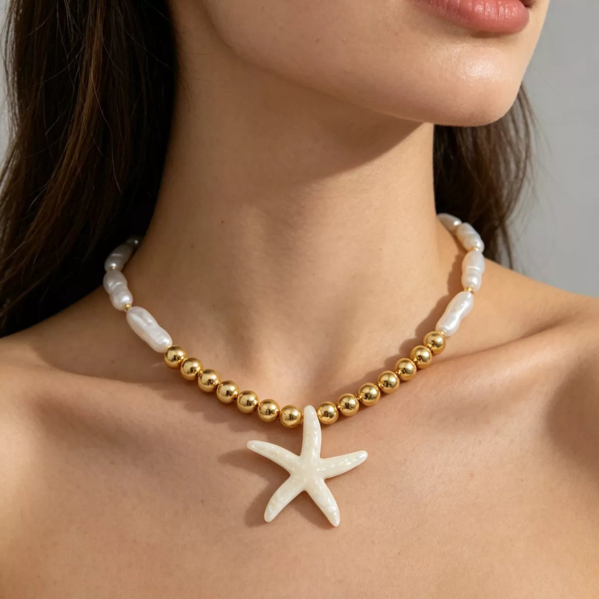Gold beaded starfish pendant necklace with pearl-look bead links