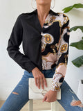 Black twist-front collared blouse with long sleeve and ornate patterned panel front
