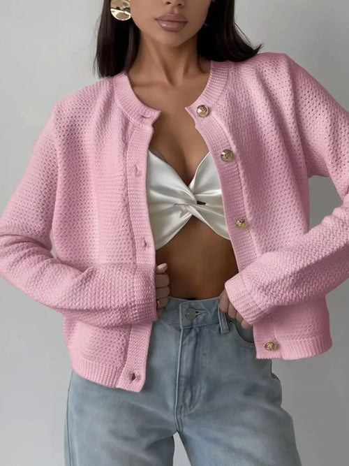 Blush pink textured knit button-front cardigan with long sleeves and ribbed cuffs