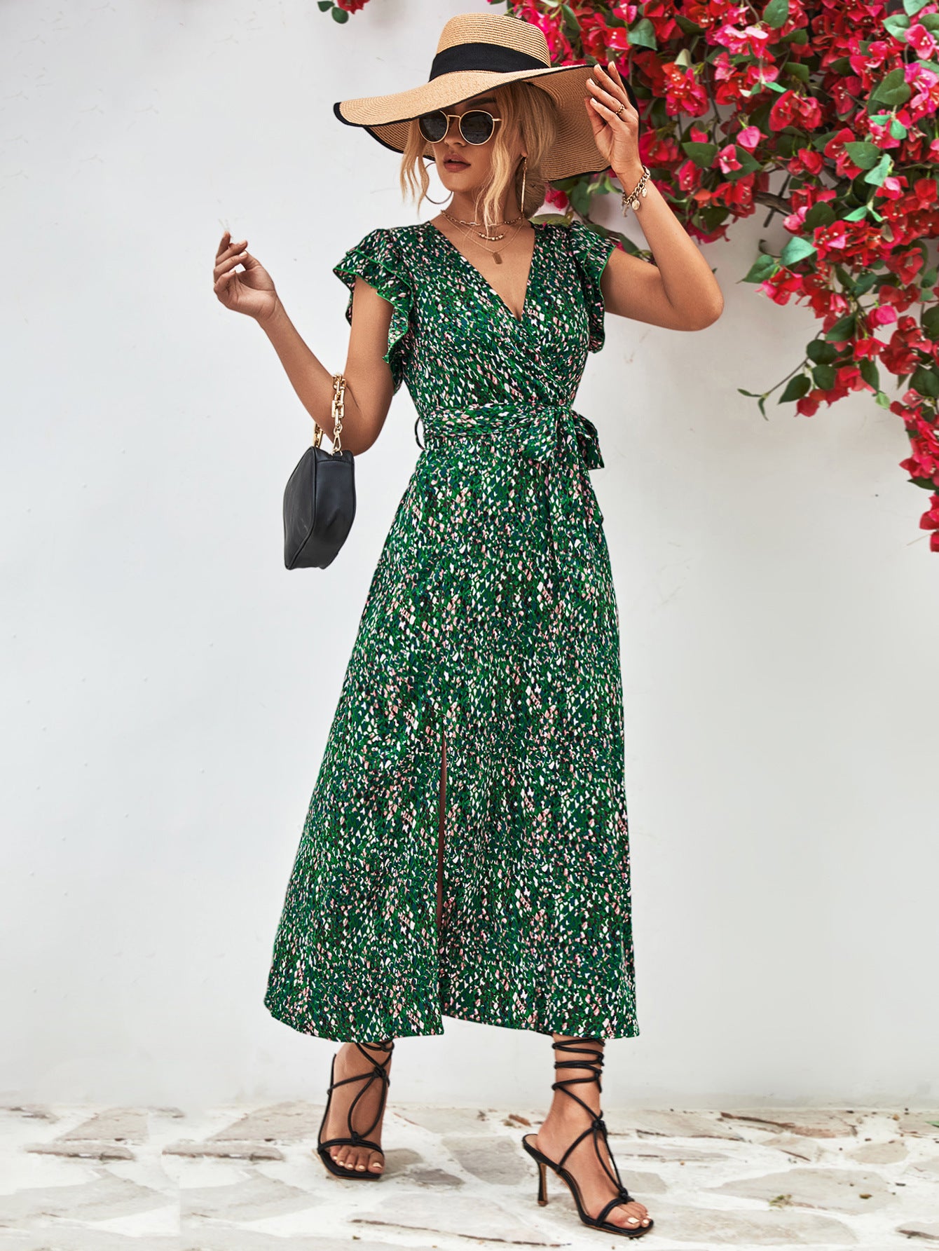 Green printed surplice neck flutter sleeve slit dress front view, midi length with side slit.