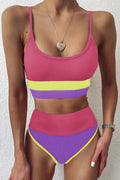 Two-piece swim set with spaghetti straps, pink fabric with purple and yellow stripes