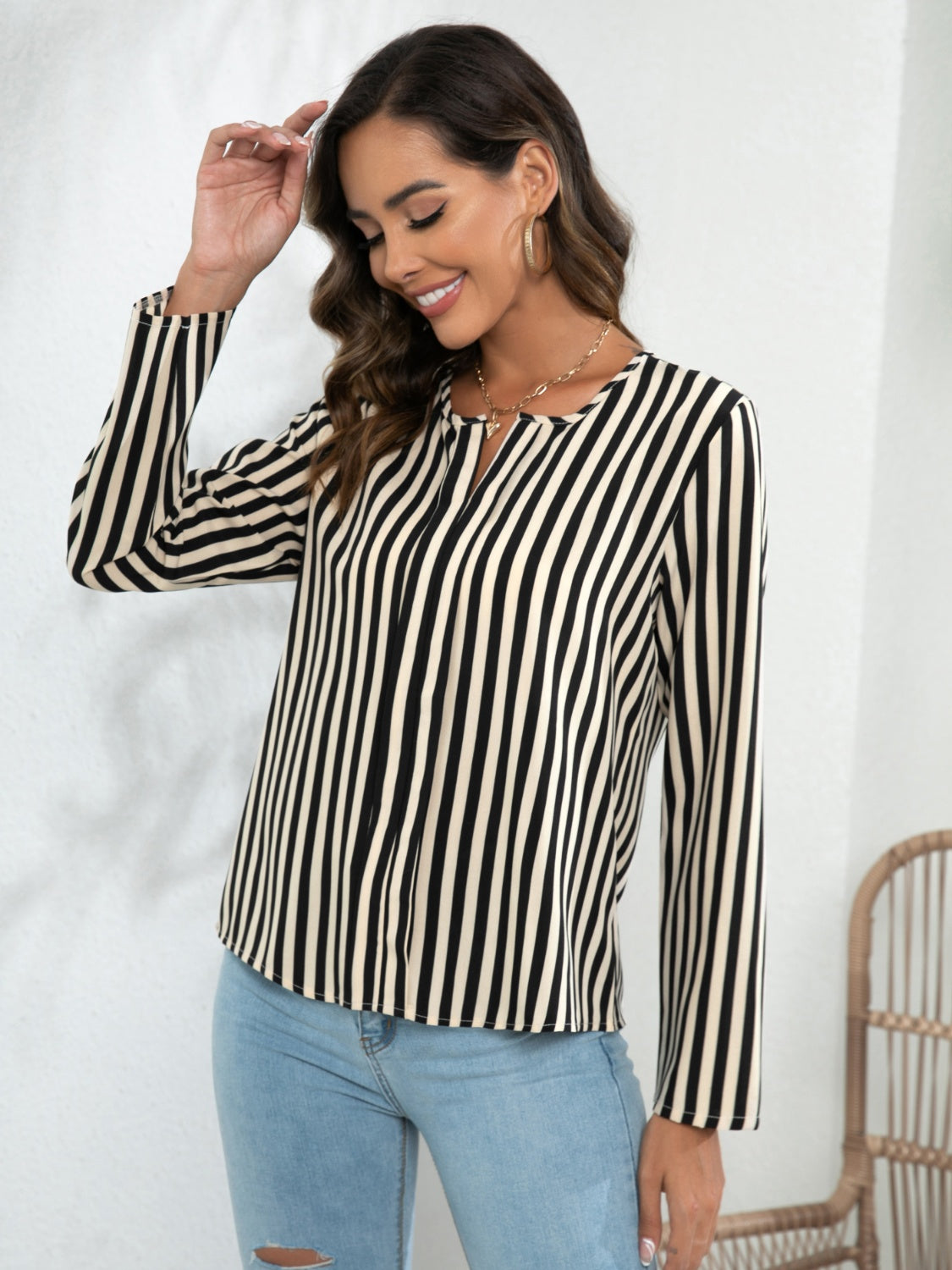 Black-and-white striped long-sleeve notched blouse with buttoned front