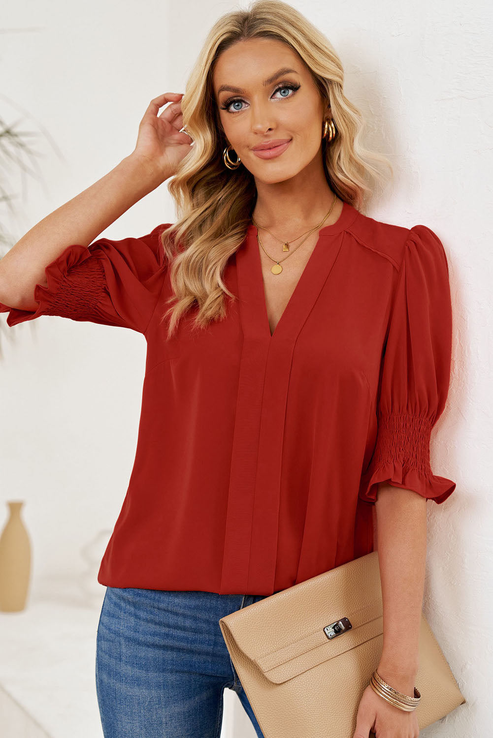 Deep red smocked flounce sleeve blouse with notched V-neck and gathered puff sleeves
