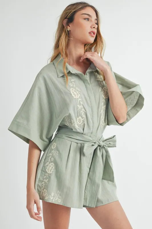 Dusty sage embroidered short-sleeve romper with collared neckline and waist tie