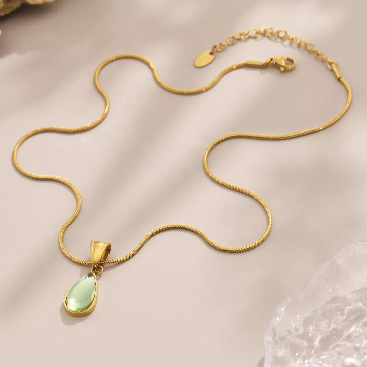 Gold-tone teardrop necklace with green glass teardrop pendant