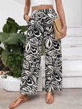 Wide-leg pants with black and white ornate floral paisley print, elastic waist