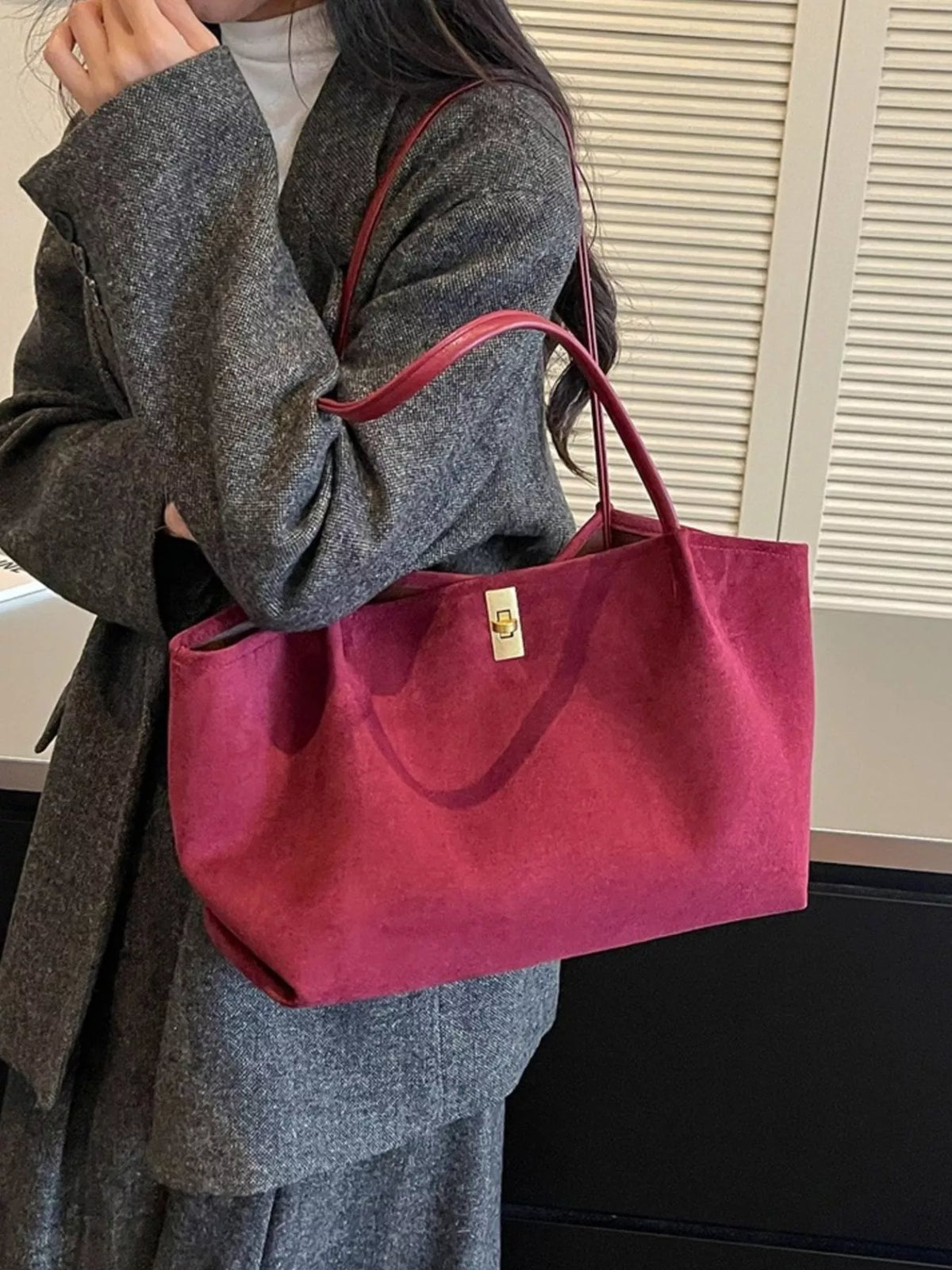 Burgundy suede medium tote bag with gold turn-lock clasp and top handles