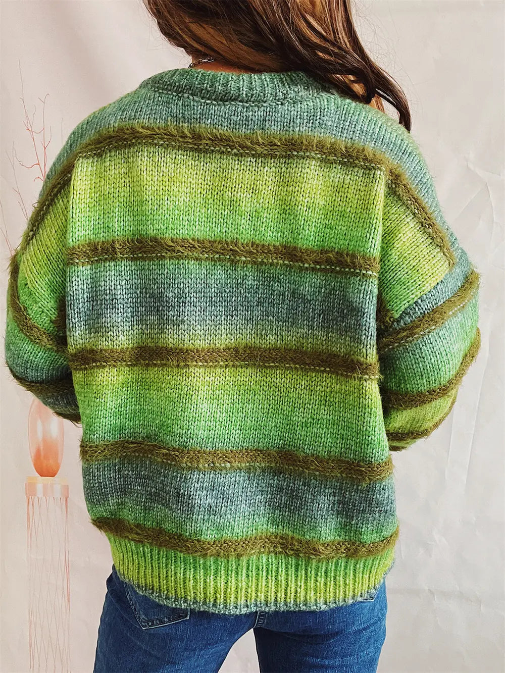 Striped round-neck long-sleeve sweater with green and gray horizontal stripes, back view