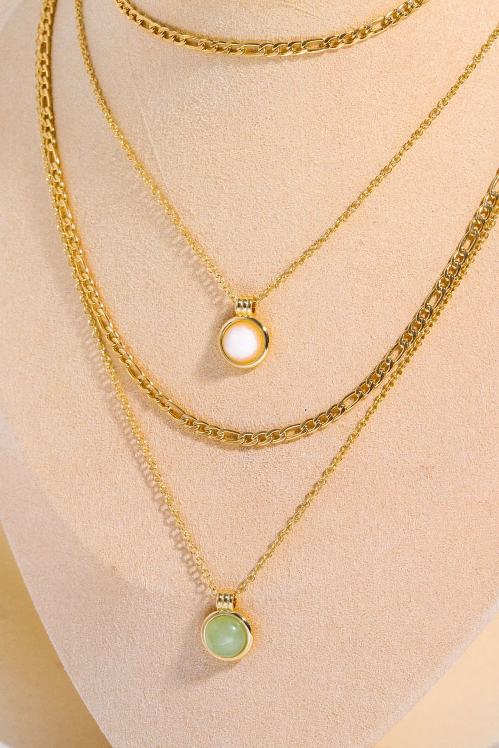 Layered gold-plated chain necklace with small round white and green pendant charms