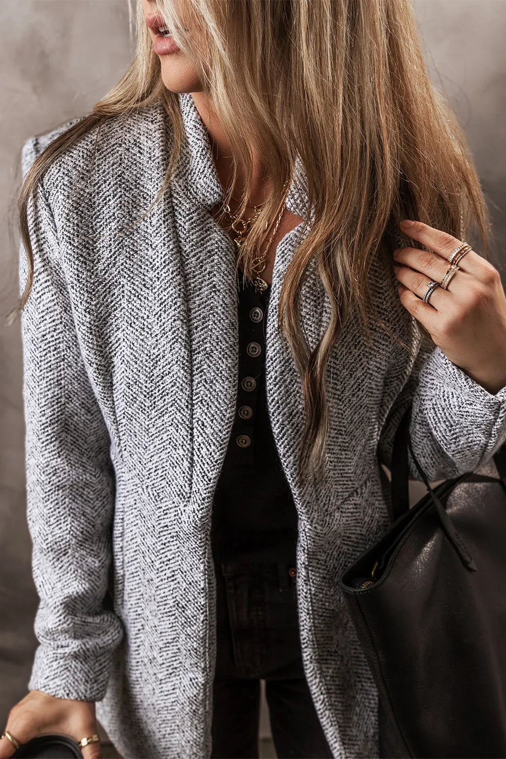 Light gray open-front long sleeve jacket, textured fabric and button-front close-up