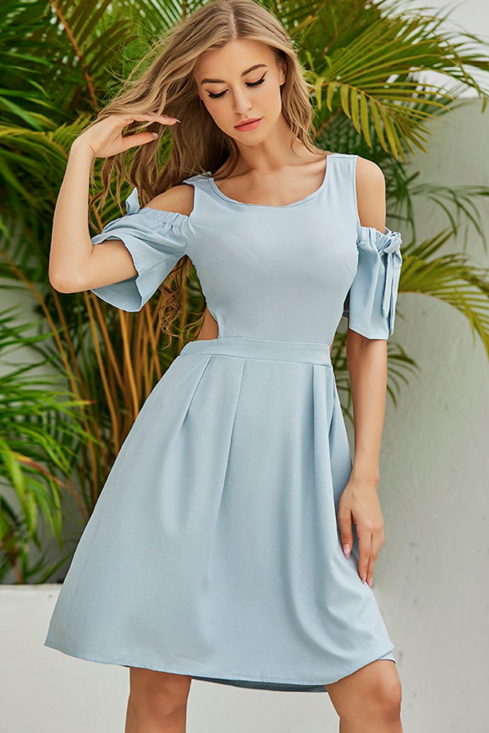 Light blue cold-shoulder dress with tied sleeves and pleated waist skirt