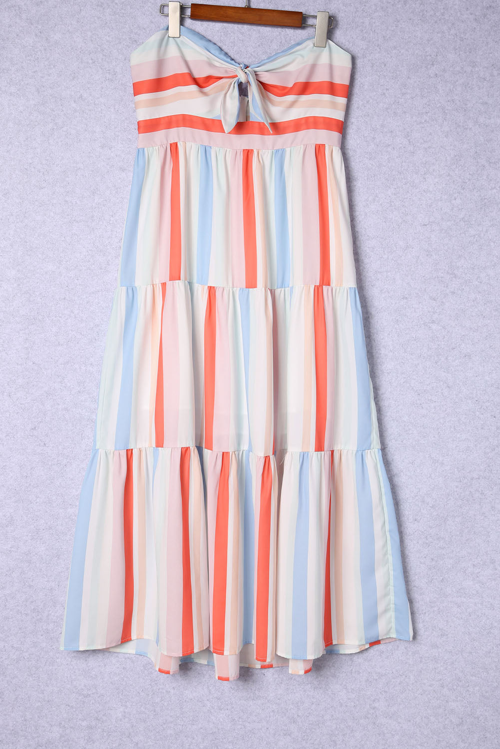 Multicolor striped strapless dress on hanger, tiered skirt with bow neckline