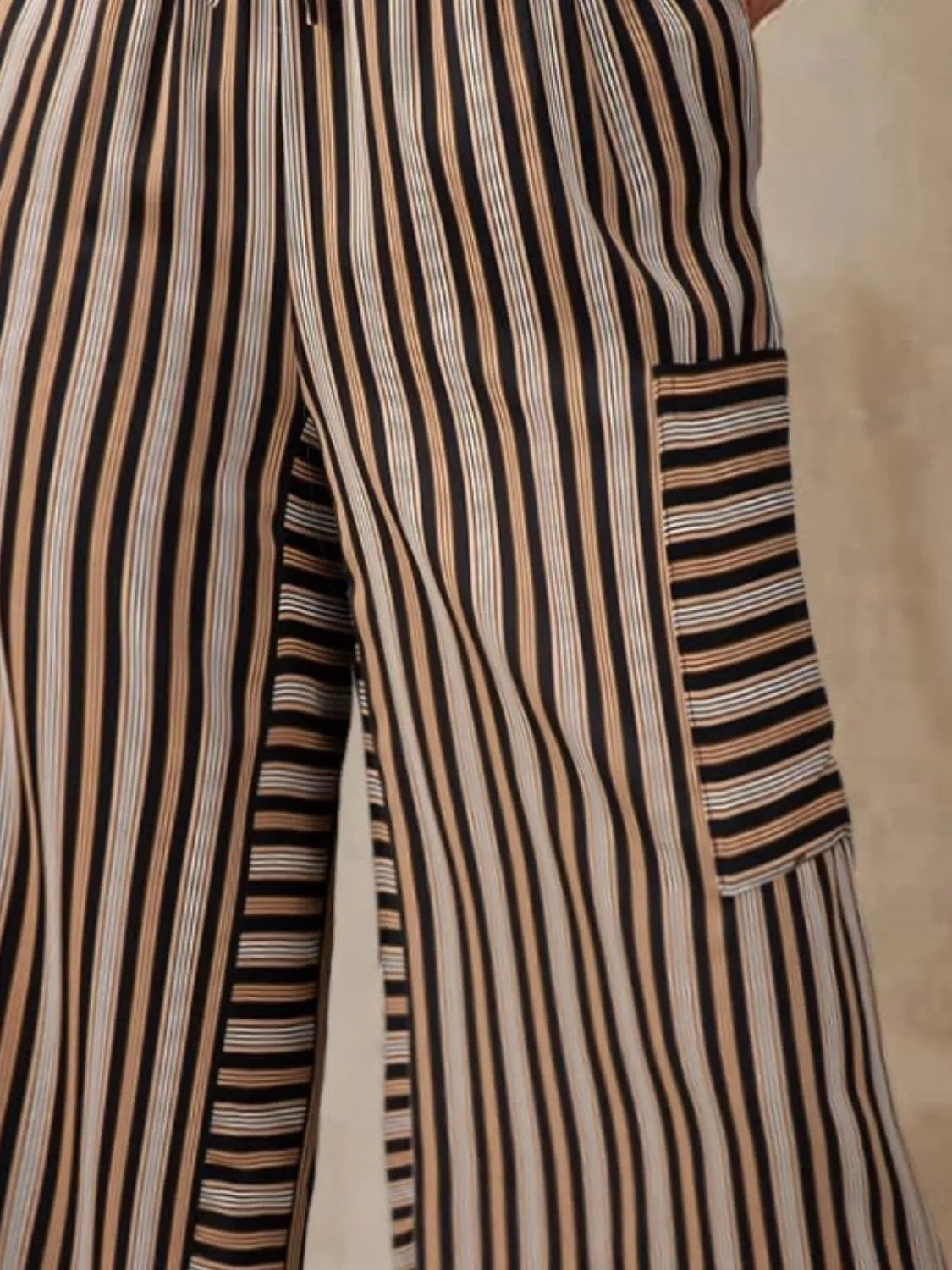 Striped wide-leg pants close-up with contrast panel pockets and elastic waist