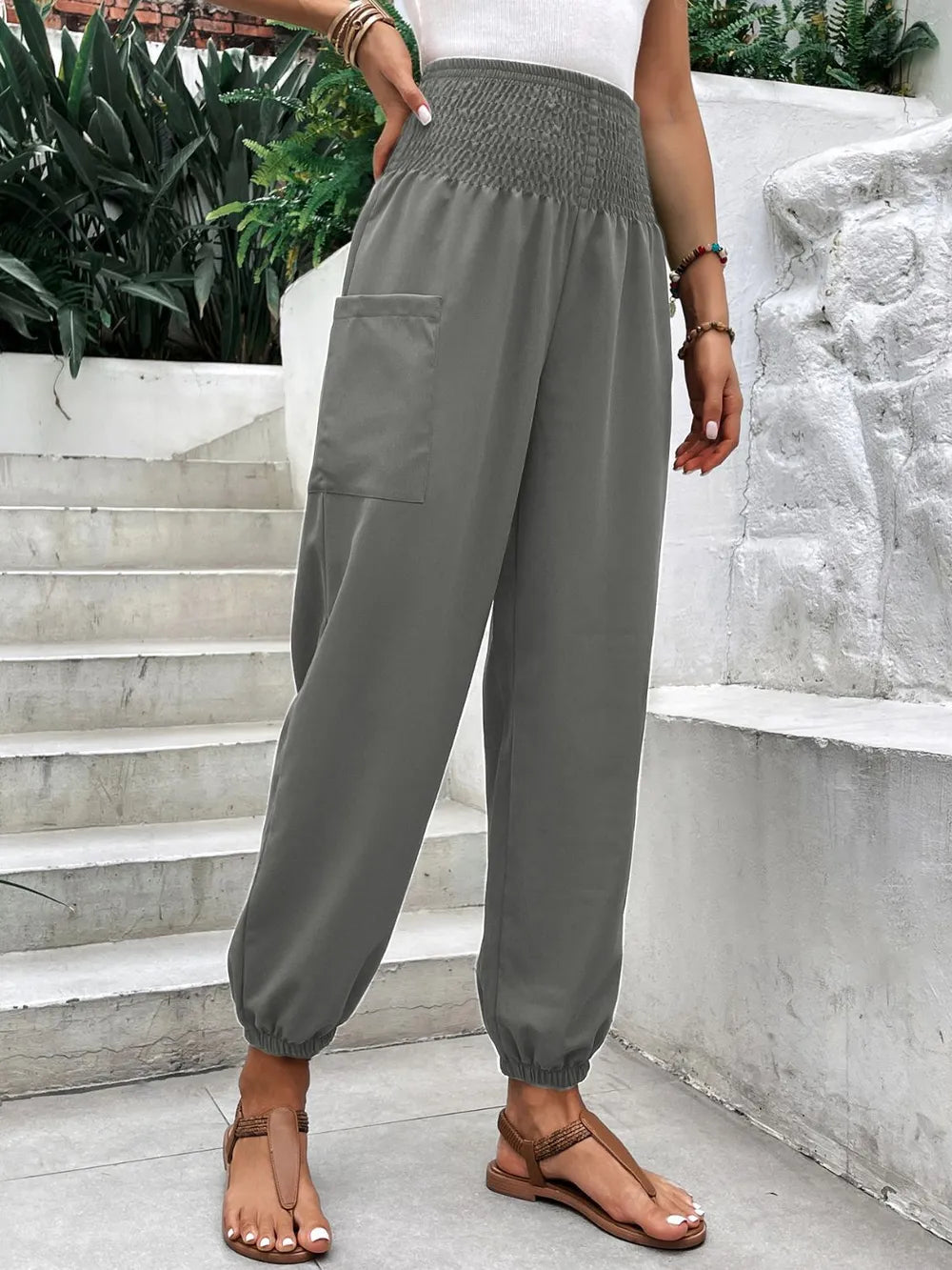 Smocked high-rise joggers with side pockets, gray loose drape, elastic cuffs