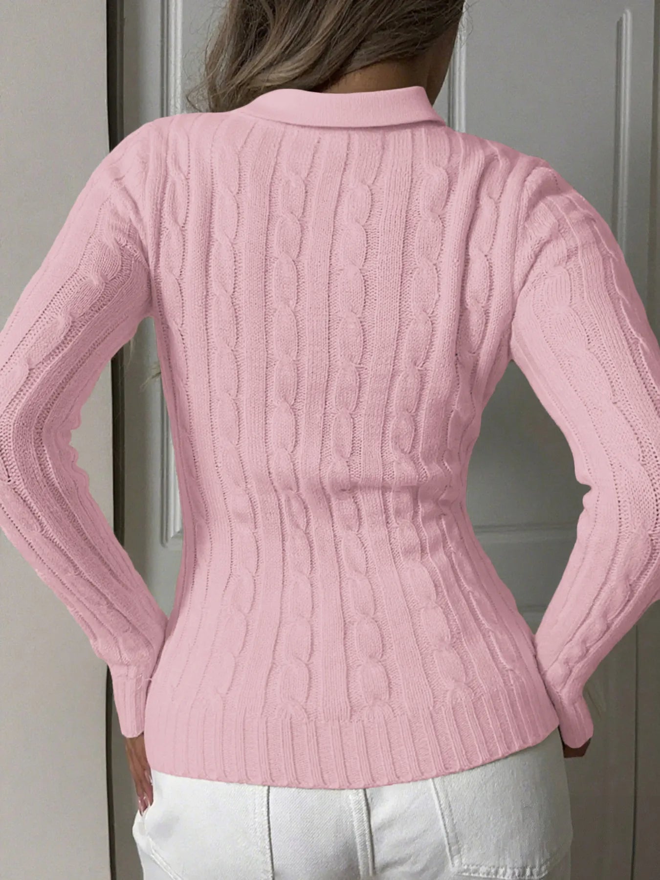 Pink cable-knit long-sleeve sweater with textured back cable pattern