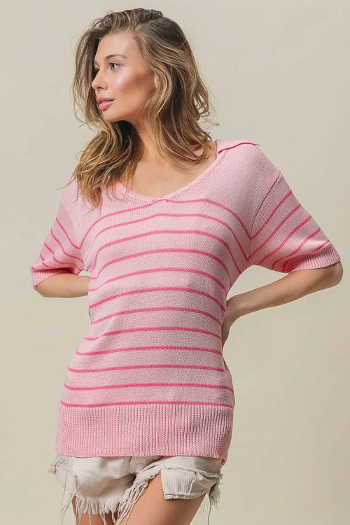Pink striped V-neck knit top with short sleeves, relaxed fit, angled side view